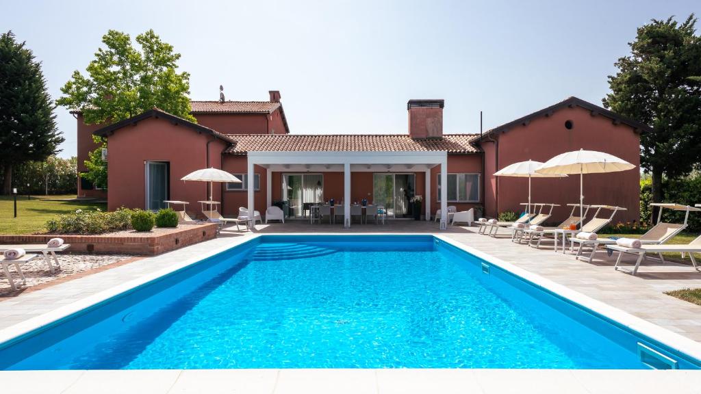 a swimming pool in front of a house at VILLA NINETTA 10&1, Emma Villas in Giulianova