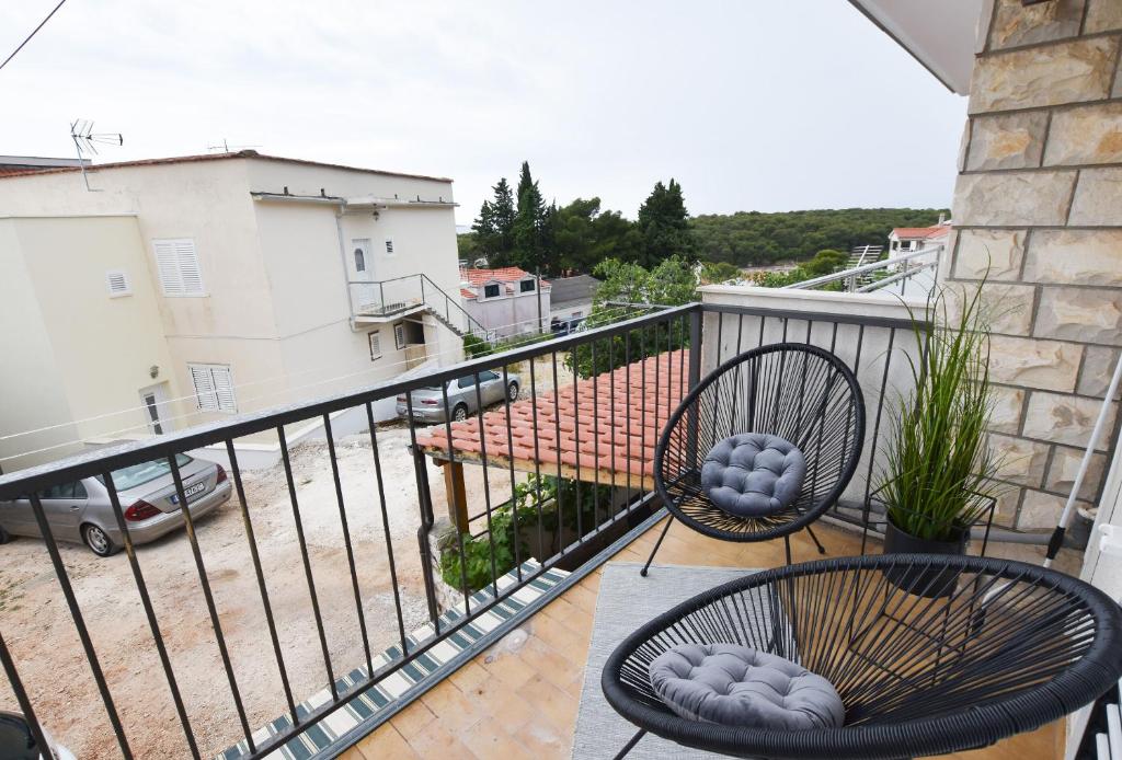 a balcony with two chairs and a balcony at Apartment Palcic in Primošten