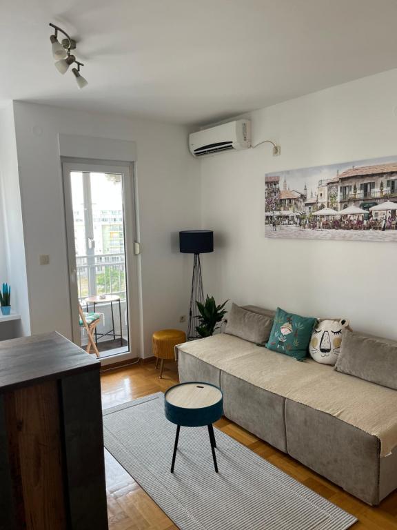 a living room with a couch and a table at Studio Pao in Podgorica