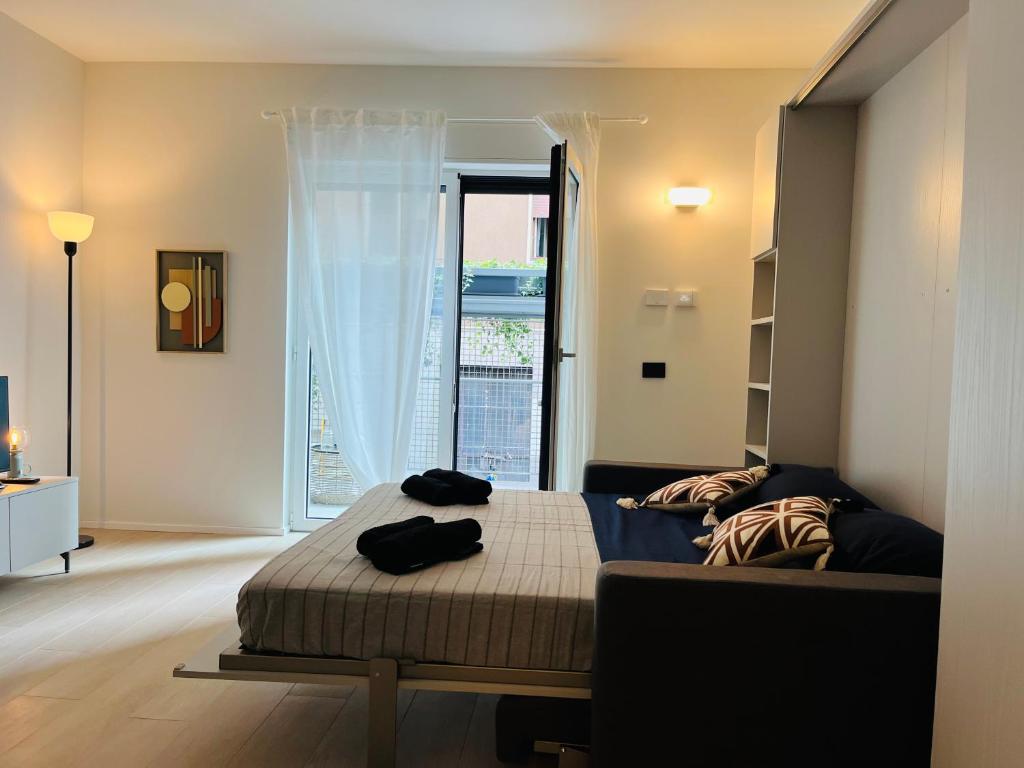 a bedroom with a bed and a large window at Studio 4 in Milan