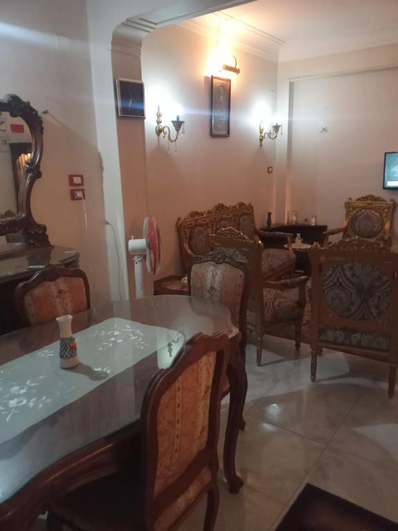 a living room with chairs and a table at Gibran residence in Kafr al Ishārah