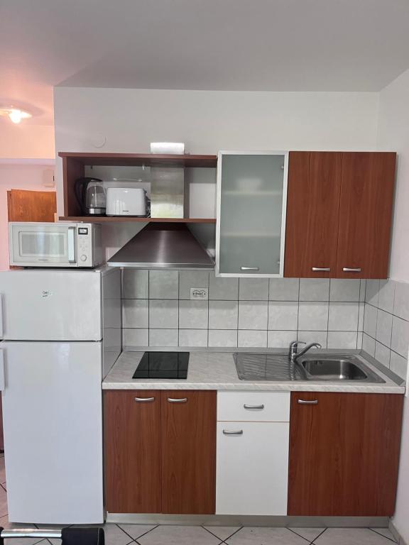 Kuchyň nebo kuchyňský kout v ubytování Apartments Nives