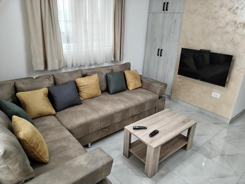 a living room with a couch and a coffee table at City Dream in Soko Banja