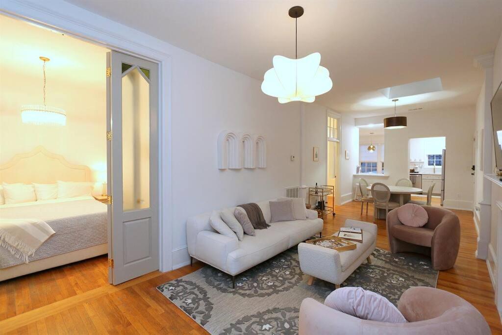 a living room with a bed and a couch and chairs at Queen Anne's Condo in Savannah