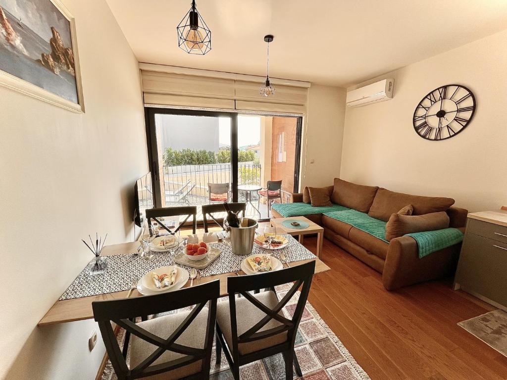 a living room with a table and a couch at Fides Stylish Apartments Tivat with Pool in Tivat