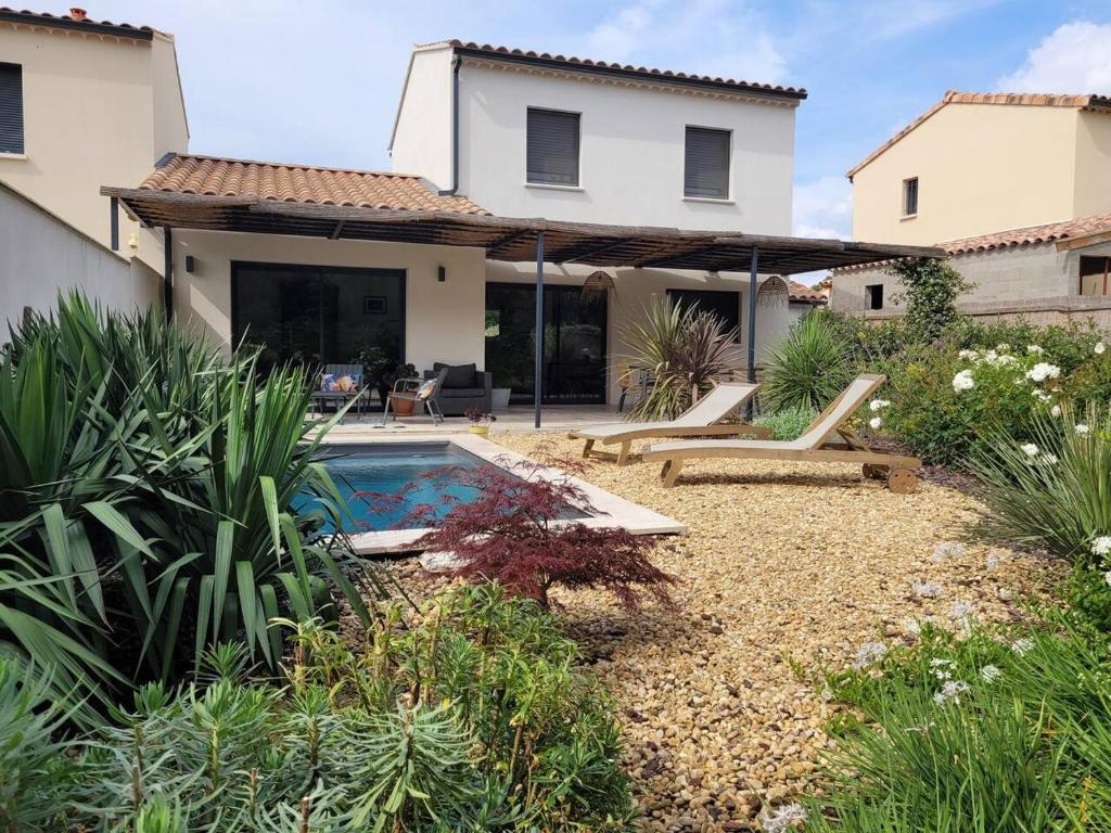 um quintal com uma piscina e uma casa em Maison Gioia em Châteaurenard