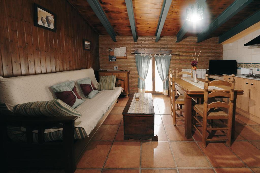 a living room with a couch and a table at Apartamentos Rurales Casa del Tio Juan in Olocau del Rey