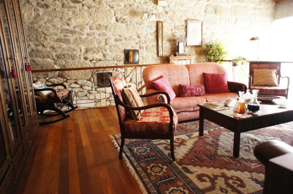 a living room with a couch and a table at Quinta Calcaterra in Marialva