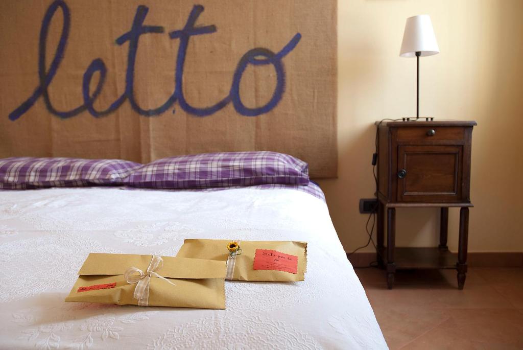 a bed with two boxes sitting on top of it at B&B Casa Pascolone in Pegognaga