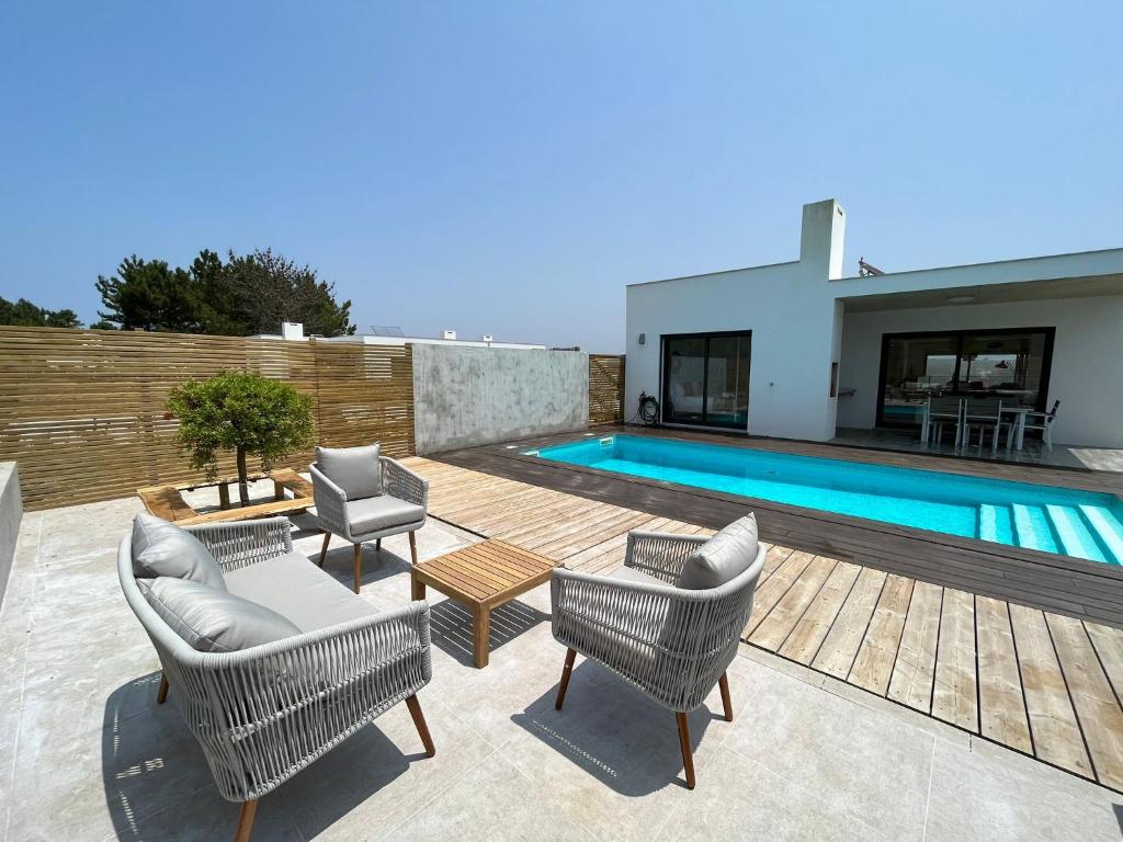 patio con sedie e piscina di Cairnvillas Villa Essencia C45 - Luxury Villa with Private Pool near Beach ad Aljezur