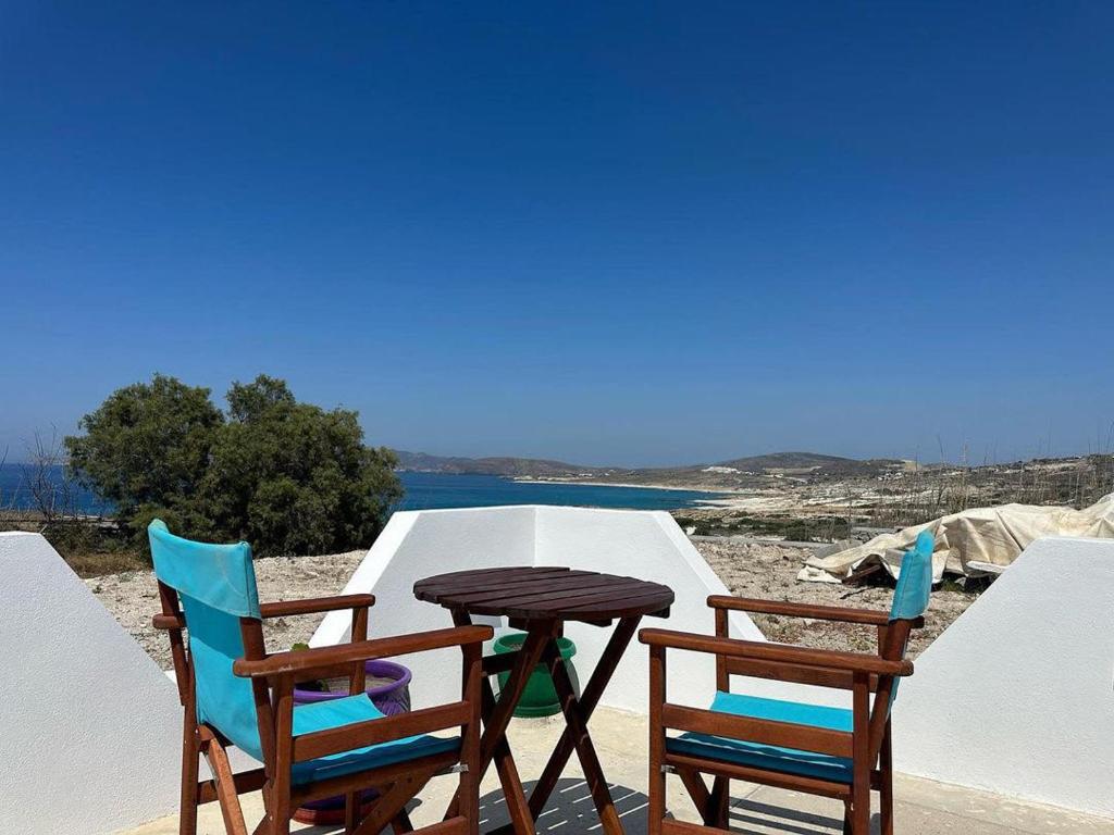 a table and two chairs and a table and chairs at AmatoNostro in Mandrakia
