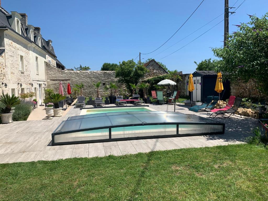a swimming pool in the yard of a house at La Douce France Trianon in Chinon
