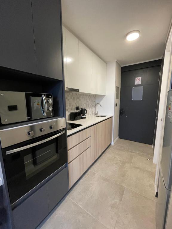 Kuchyň nebo kuchyňský kout v ubytování Epicentro Suites Apart Hotel - Valdivia