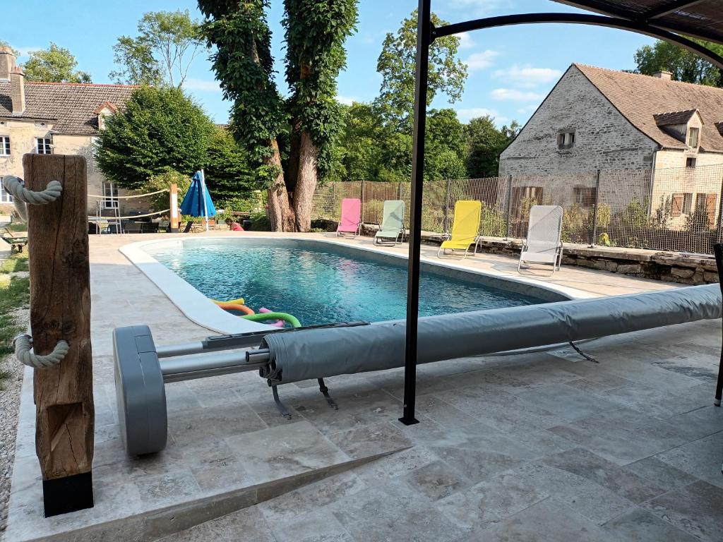 a large swimming pool with a inflatable at La Maison des Maîtres de Forge in Moloy