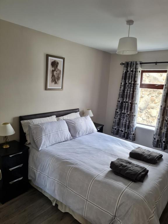 a bedroom with a large bed with two pillows on it at sea view apartment in Letterkenny