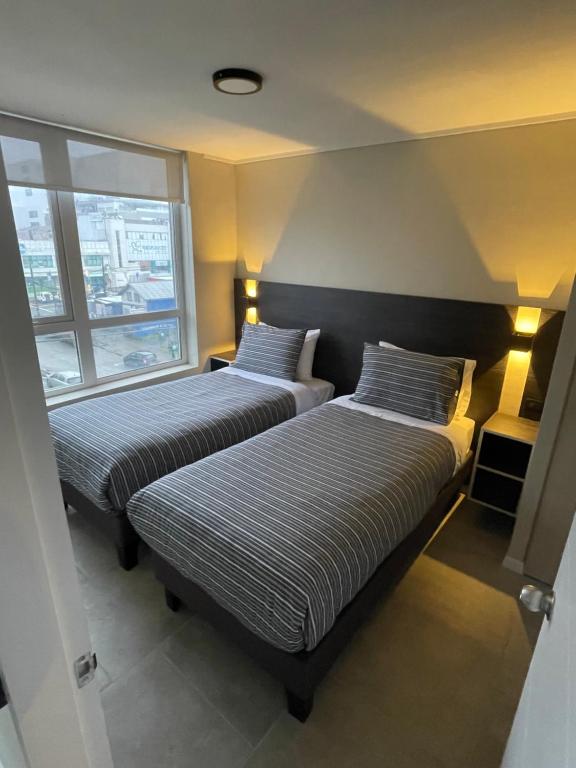 Postel nebo postele na pokoji v ubytování Epicentro Suites Apart Hotel - Valdivia