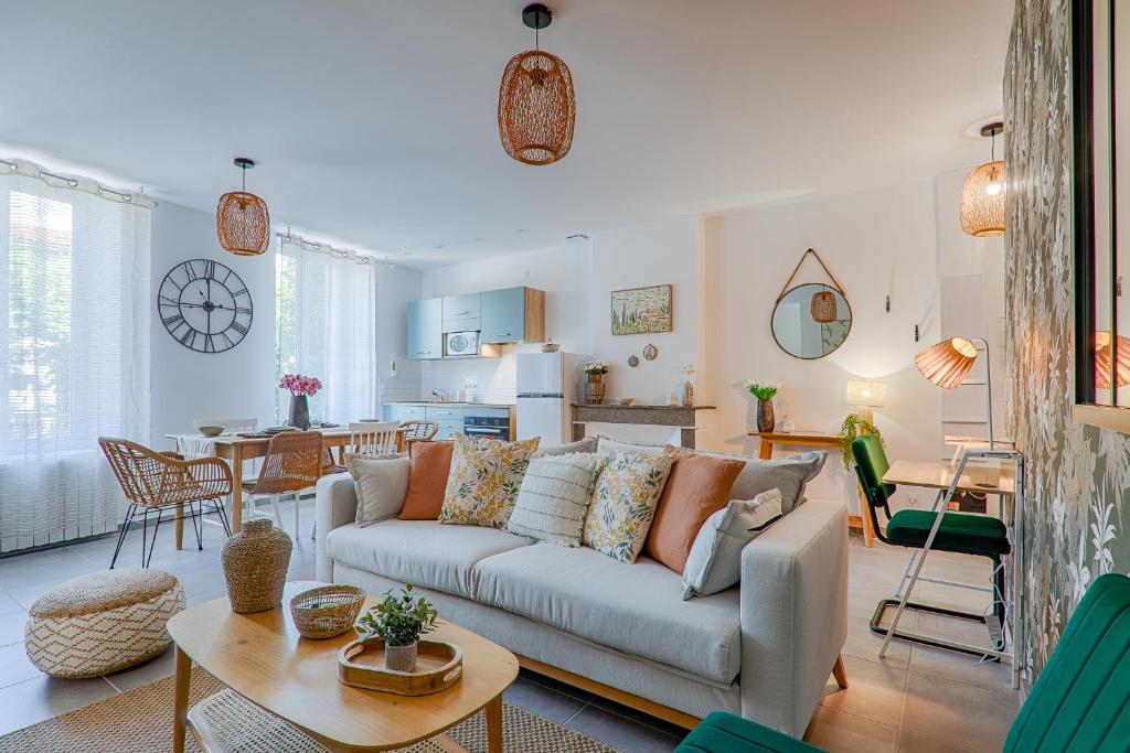 a living room with a couch and a table at La Bouverie in Romans-sur-Isère