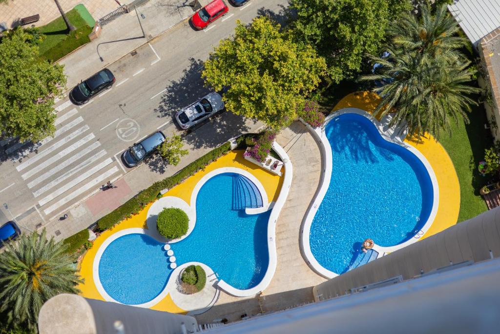 an overhead view of two swimming pools in a parking lot at Mediterranean Blue by Fidalsa in Benidorm