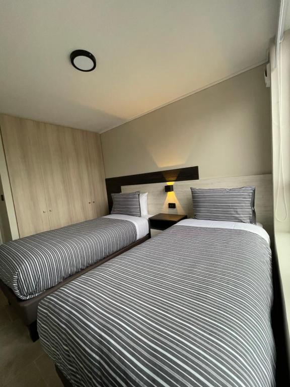 Postel nebo postele na pokoji v ubytování Epicentro Suites Apart Hotel - Valdivia