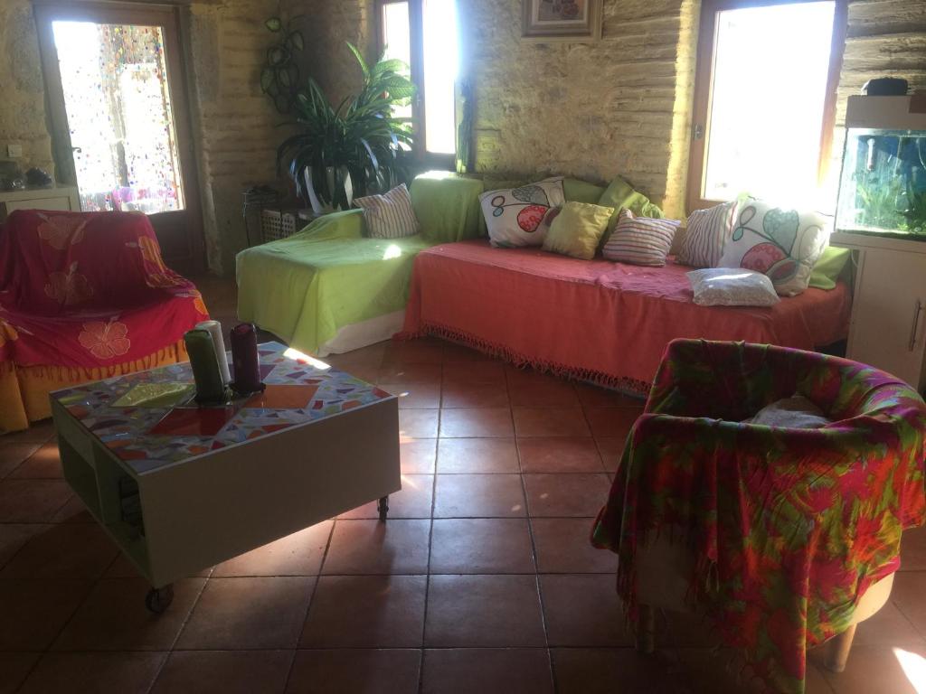 a living room with a couch and a table at L&#39;écrin - Chambres d&#39;hôtes au calme et au vert 