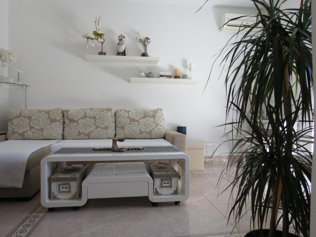 a living room with a couch and a coffee table at Eco friendly apartment in Ližnjan