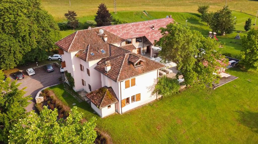 an overhead view of a large white house with a yard at Nogherazza - La Locanda in Belluno