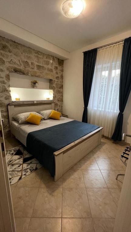 a bedroom with a large bed in a room at Grošovi Dvori in Opuzen