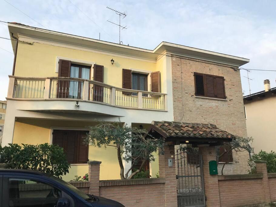 a large house with a balcony on top of it at Villa Parisi in Fano