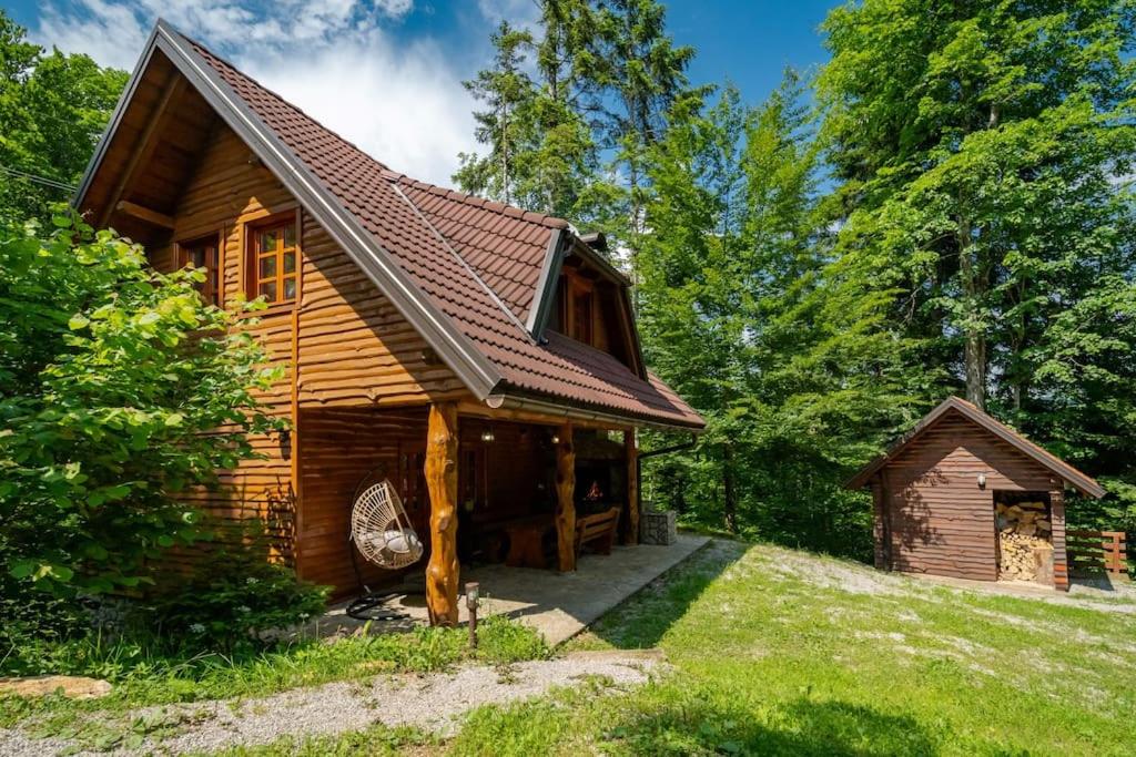 a log cabin in the middle of a forest at Forest Amerika - Ivcakova koliba in Vrbovsko