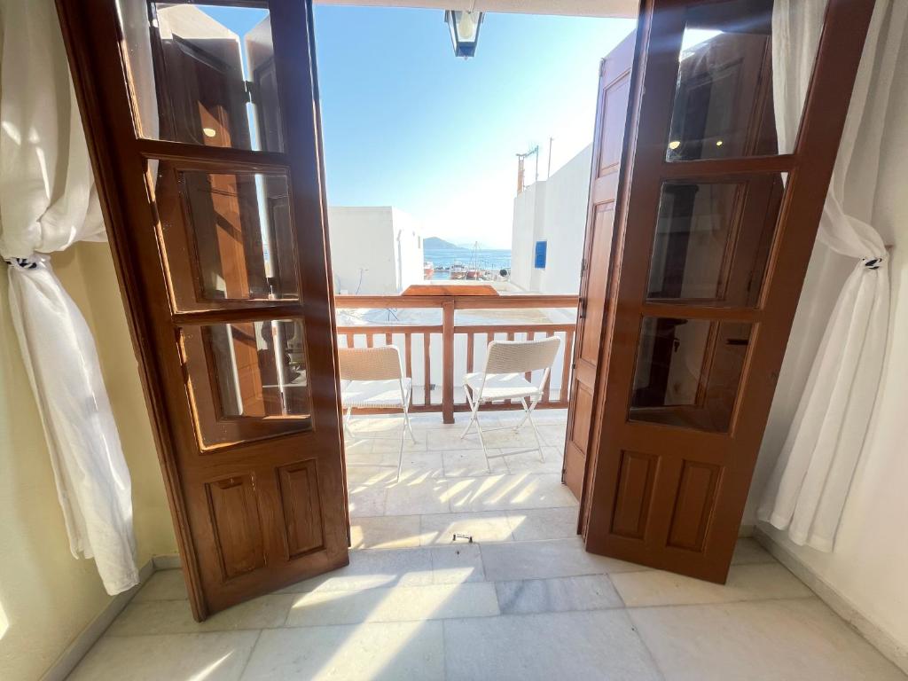 an open door with a view of a balcony at Under the Castle - In the heart of the Old Town in Naxos Chora