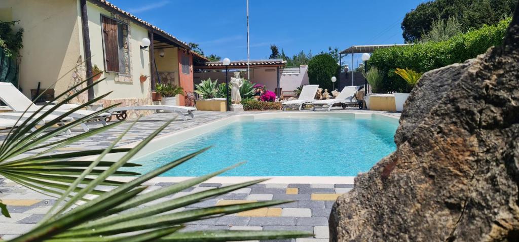 a swimming pool in front of a house at Gulliver's Nest in Castellammare del Golfo