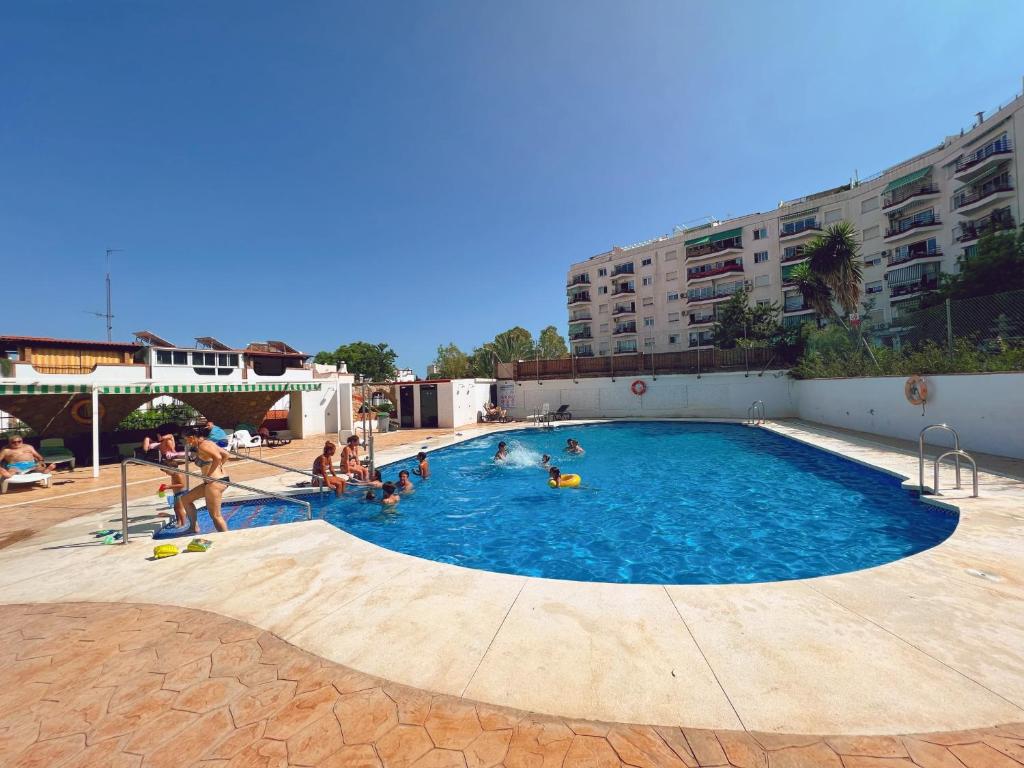 a group of people playing in a swimming pool at Mi Sueño by Residea in Torremolinos