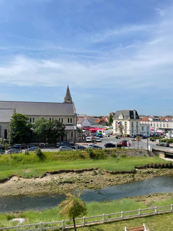 a town with a river and a church at Studio Wimereux vue dégagée, proche mer, exposition sud in Wimereux