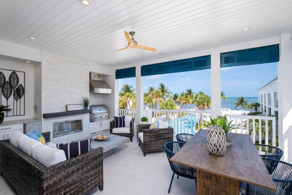 a living room with a table and chairs at Islamorada Modern Penthouse with Private Beach in Islamorada