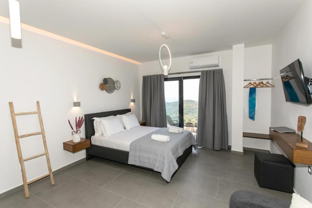 a bedroom with a bed and a ladder and a window at Gaia Apartments I in Anthoúsa