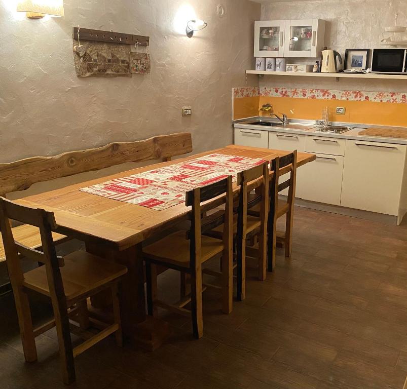 a kitchen with a wooden table and some chairs at Maison Maribel 0043 in Pré-Saint-Didier
