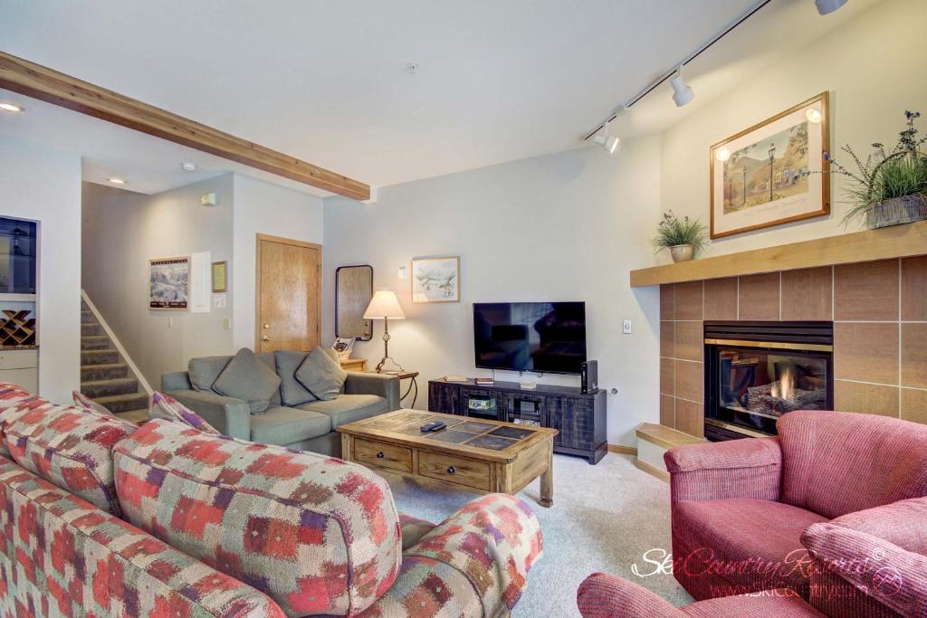 a living room with two couches and a fireplace at Ski In & Out Townhome - Close Proximity to Summer Hiking Trails & Main St Breck ANT23 in Breckenridge