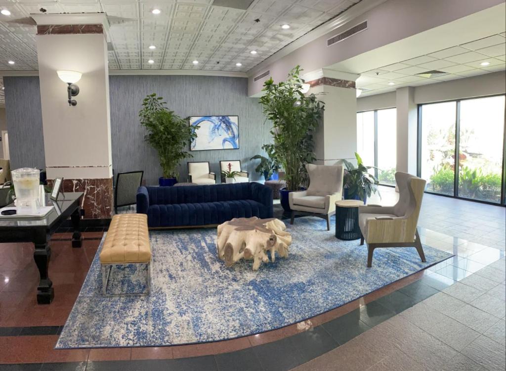 a lobby with a living room with a bear statue on a rug at Wyndham Houston near NRG Park - Medical Center in Houston