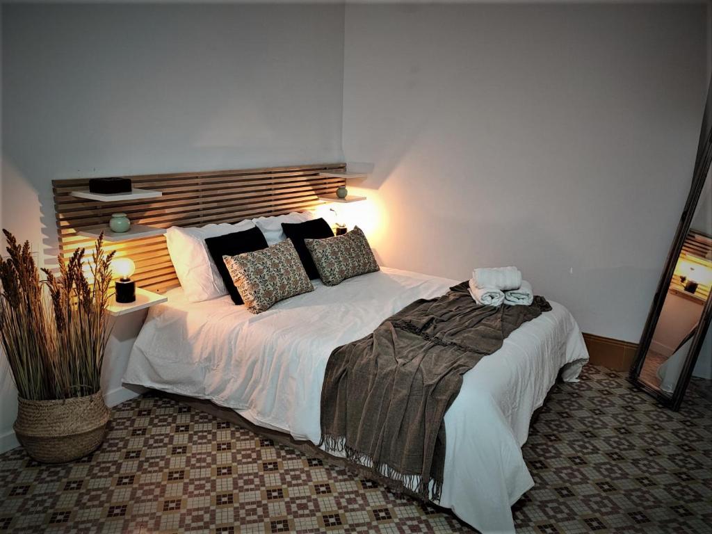 a bedroom with a large white bed with pillows at BS apartamentos Aledo14 in Novelda