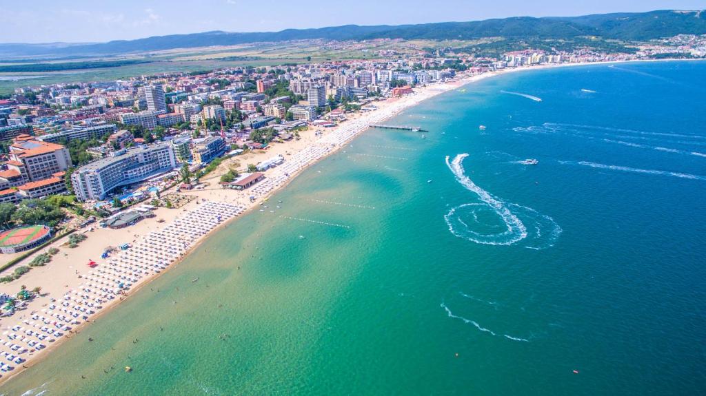 an aerial view of a beach with a boat in the water at SUNNY SEA PALACE 502 Studio Sunny Beach in Sunny Beach