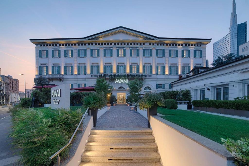 a large white building with a pathway in front of it at Avani Palazzo Moscova Milan Hotel -Previously NH Palazzo Moscova- in Milan