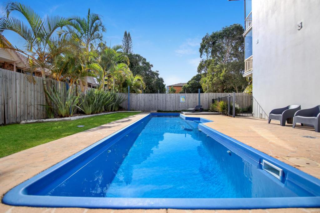 a swimming pool in the backyard of a house at Ocean Spray 7 in Coffs Harbour