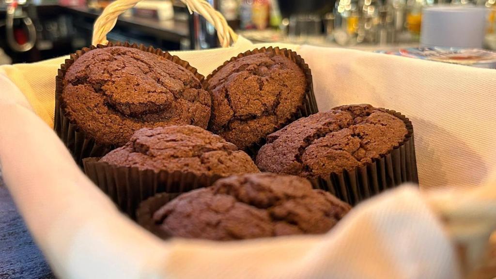 una cesta de magdalenas de chocolate sentadas en una mesa en The Wellington Hotel Birmingham - Breakfast Included City Centre Near O2 Academy en Birmingham