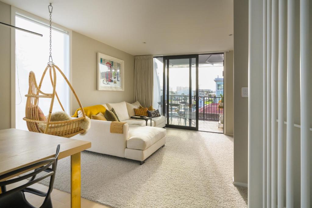 a living room with a couch and a swing at Downtown Mount Maunganui in Mount Maunganui
