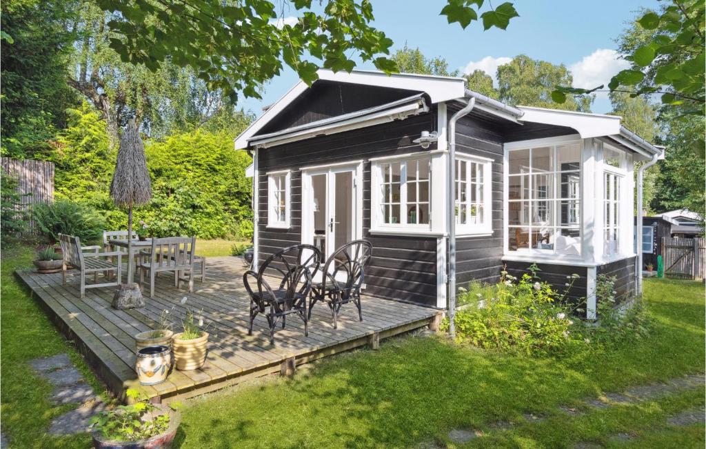 a black and white tiny house with a deck at Awesome Home In Hornbk With Wifi in Hornbæk