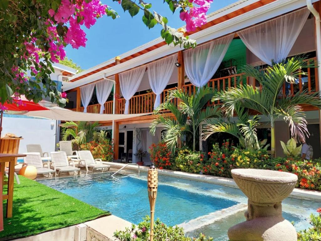 a villa with a swimming pool and a resort at BellaVista Suites By Villas Verdes - Samara Beach in Sámara