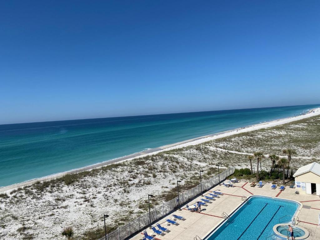 a view of the beach from the balcony of a resort at Your Beach Therapy Awaits at Sans Souci in Pensacola Beach