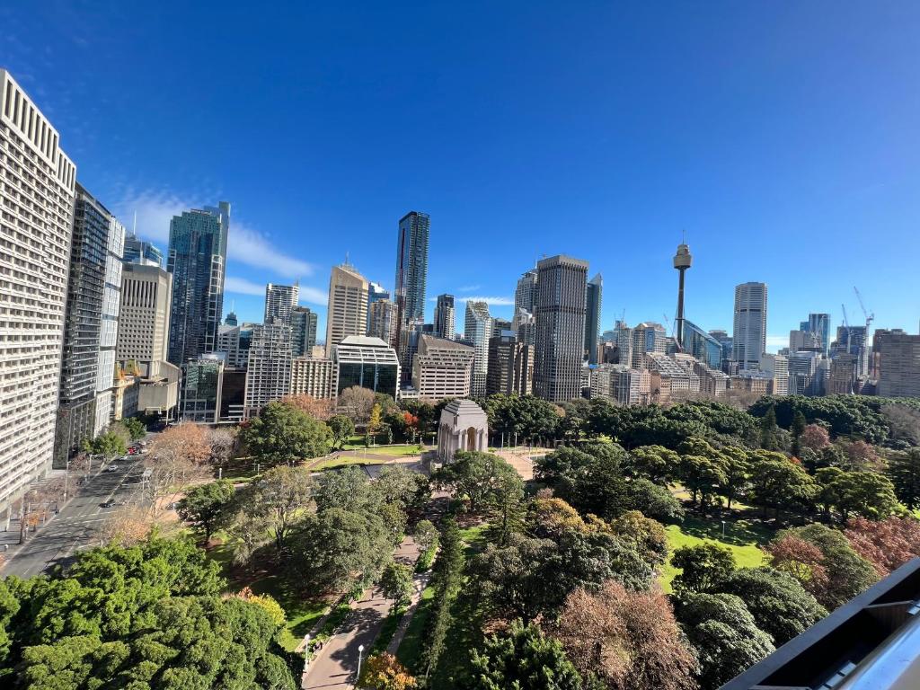 a view of a city skyline with tall buildings at Paxsafe Sydney Hyde Park Private Apartments in Sydney