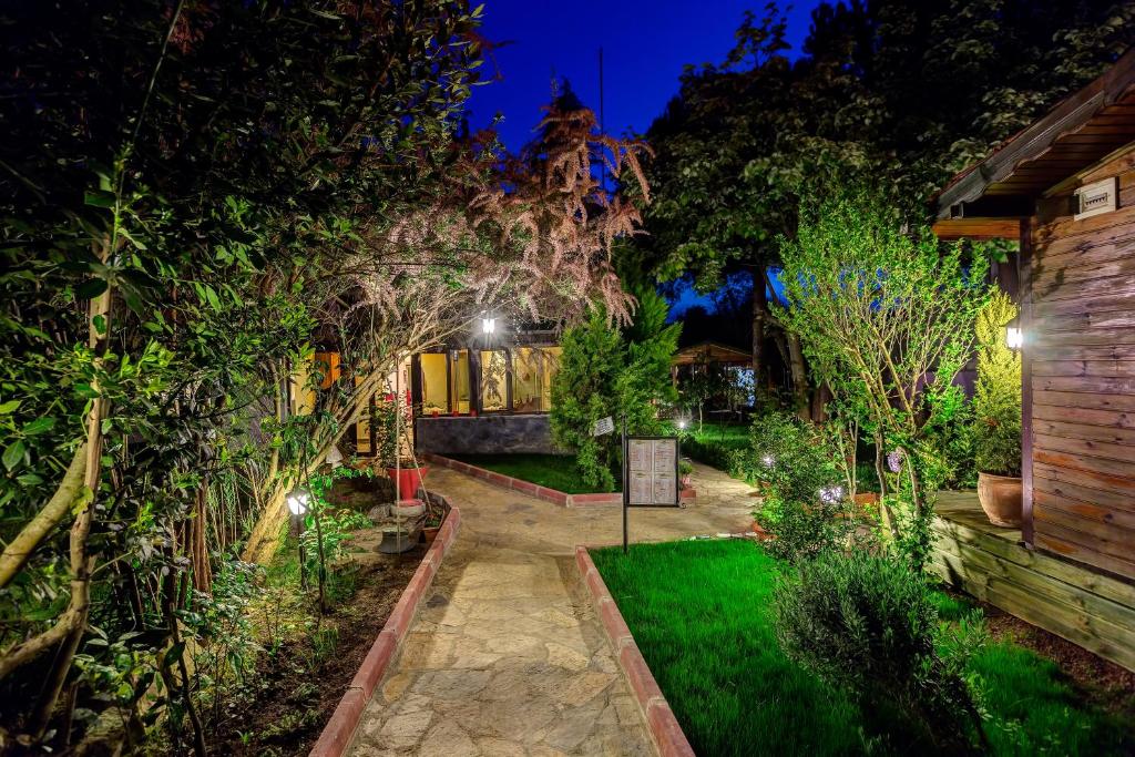 a garden at night with trees and a building at Park Mandalin Hotel - Adult only in Ağva