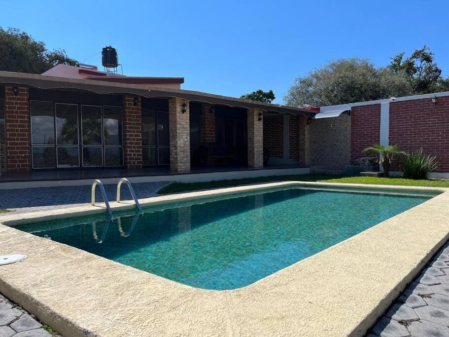 a swimming pool in front of a house at Casa San Pedro in San Pedro Tesistán